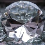 a diamond sitting on top of a pile of glass